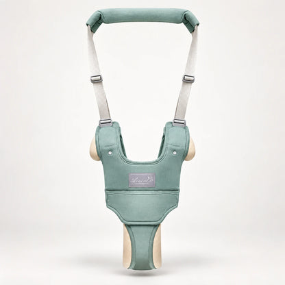 Front view of the green baby walking harness with padded handle and adjustable straps
